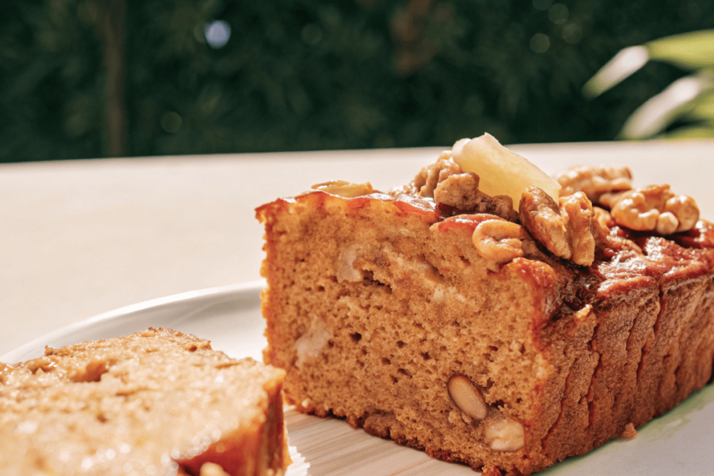 Slice of banana bread with walnuts and butter